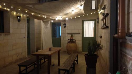 a room with a table and chairs and lights at B&b Miele&mare in Melendugno