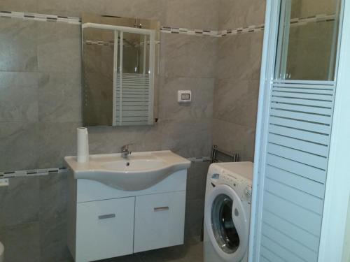 un bagno con lavandino e lavatrice di Senza Pensieri a Galatone