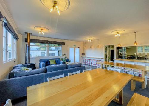 a living room with a blue couch and a wooden table at Kinloch Wilderness Retreat in Glenorchy