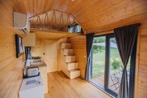 an interior view of a tiny house with a loft at La Casa Errante X by Tiny Away in Castilenti