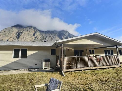 a house with a mountain in the background at Herrera Estate Private Two-Home Retreat in Keremeos