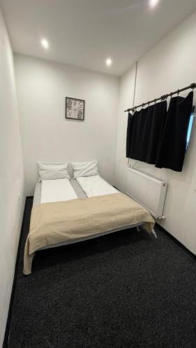a bedroom with a bed in a white room at Chill House in Deva