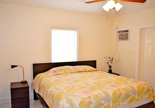 a bedroom with a bed and a ceiling fan at Ocean Drive Villas in Hollywood
