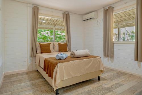 a bedroom with a bed with two pillows on it at Pousada Vila Sossego in Lençóis