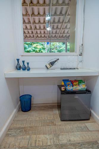 a window in a room with a counter and a table at Pousada Vila Sossego in Lençóis