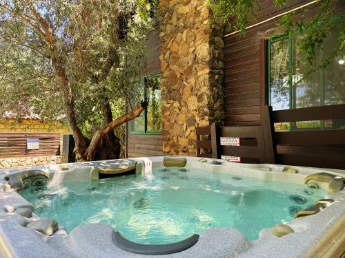 a hot tub in front of a house at THE HOUSE ROSH PINA - 2BRM WITH POOl in Rosh Pinna