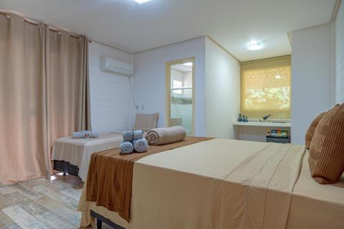 a bedroom with a large bed and a sink at Pousada Vila Sossego in Lençóis