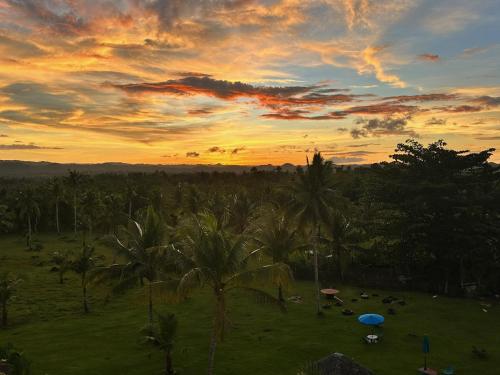 Matahari terbit atau terbenam yang dilihat dari penginapan di ladang atau berdekatan