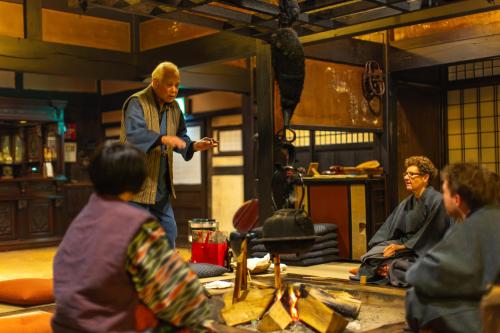 a man standing in a room with a group of people at Wanosato in Takayama