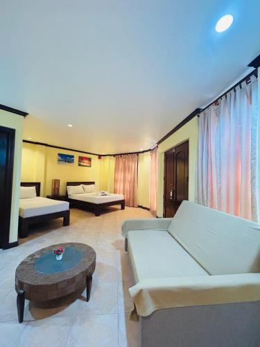 a living room with a couch and a coffee table at Sheridan Villas Boracay in Boracay