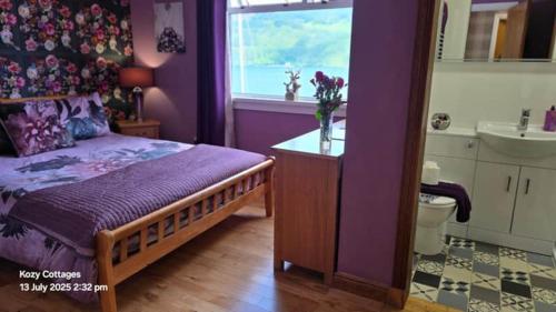 a purple bedroom with a bed and a sink at Jenny's Bay with Hot Tub in Lochgoilhead