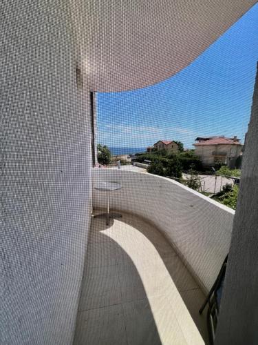 a view of a walkway on a white wall at Family hotel Delfina in Tyulenovo