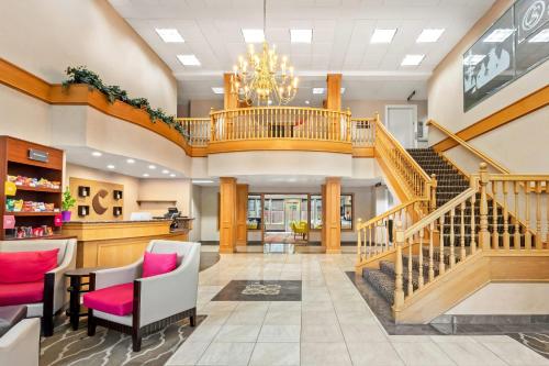 a large lobby with a staircase and a chandelier at Comfort Suites Clackamas in Clackamas