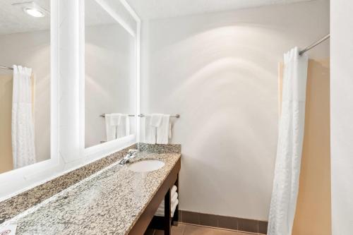 a bathroom with a sink and a mirror at Comfort Suites Clackamas in Clackamas