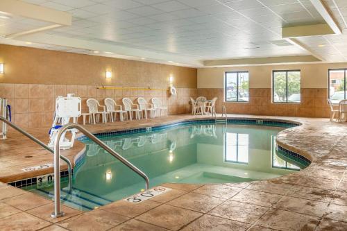 a pool in a hotel room with chairs around it at Sleep Inn & Suites Milwaukee Airport in Milwaukee