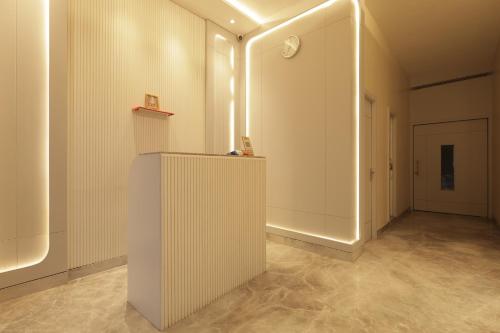 a room with a white wall and a hallway at Lakefront Hotel by Brijwasi in Mathura
