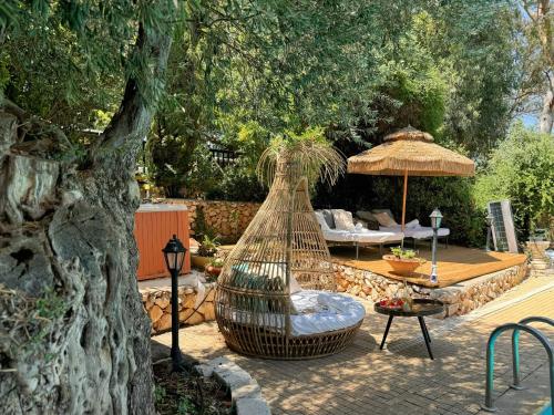 a hammock sitting under a tree in a yard at THE HOUSE ROSH PINA - 3BRM WITH POOl in Rosh Pinna