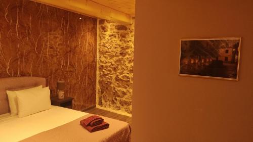 a bedroom with a bed and a picture on the wall at Casa Stratigos in Corfu