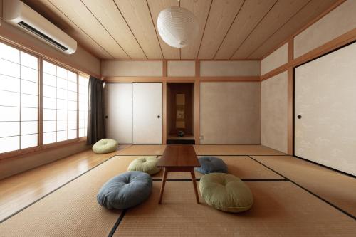 a room with a table and two bean chairs at Ekichika TABI-NE in Kanazawa