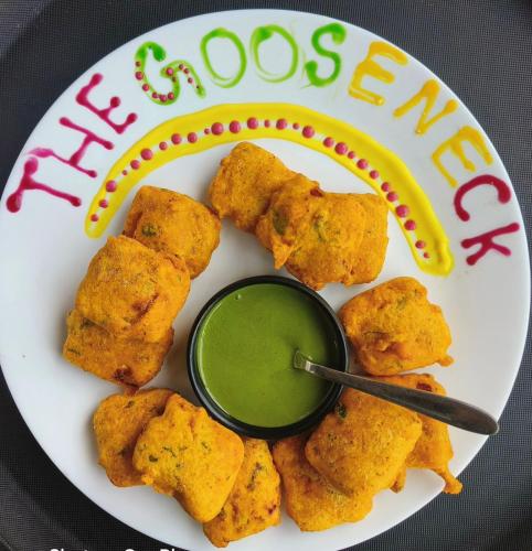 a plate of food with green sauce on it at GOOSENECK HOTEL and RESTAURANTS in Kandogal