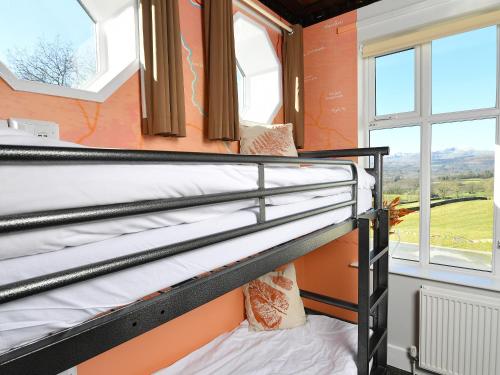 two bunk beds in a room with a window at YHA Windermere in Troutbeck