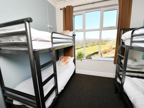 a dorm room with bunk beds and a window at YHA Windermere in Troutbeck