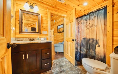 a bathroom with a toilet and a sink at Grand Mountain View in Pigeon Forge