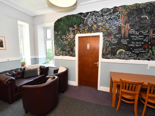 a living room with a couch and a table at YHA Windermere in Troutbeck