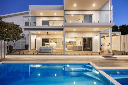 a house with a swimming pool in front of it at Luxury Pool Sauna Spa Tennis Court in Mount Martha