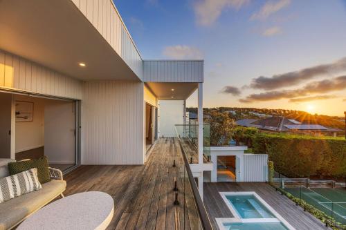 a balcony of a house with a swimming pool at Luxury Pool Sauna Spa Tennis Court in Mount Martha