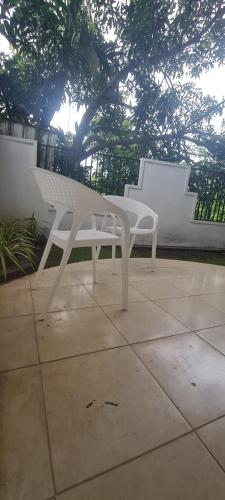 a white bench sitting on top of a sidewalk at Ranketha Hideout Resorts in Kurunegala
