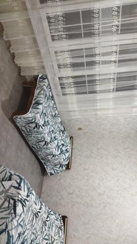 two beds sitting next to a window in a room at TamoLand in Astara