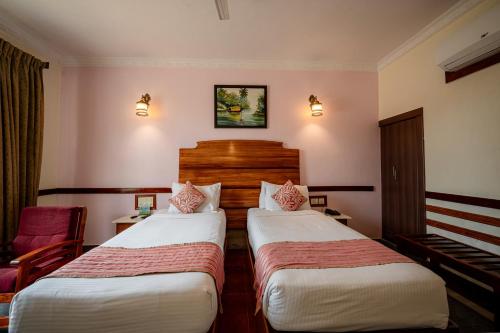 a hotel room with two beds and a piano at Hotel Presidency Kempegowda International Airport Bangalore in Devanahalli-Bangalore