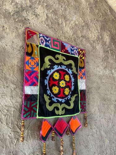 a rug with a flower on it on a table at Сайма Таш in Bokonbayevo