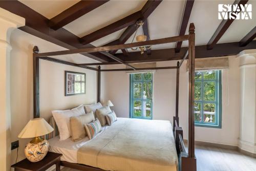 a bedroom with a large bed in a room at StayVista at The Emily Chalet 7 BR House in Nainital with Bonfire, BBQ in Nainital