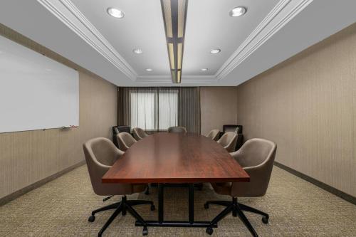 a conference room with a wooden table and chairs at SpringHill Suites Minneapolis Eden Prairie in Eden Prairie