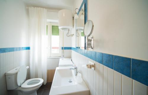 a bathroom with a toilet and a sink and a mirror at La Terrazza sul Mare in Letojanni