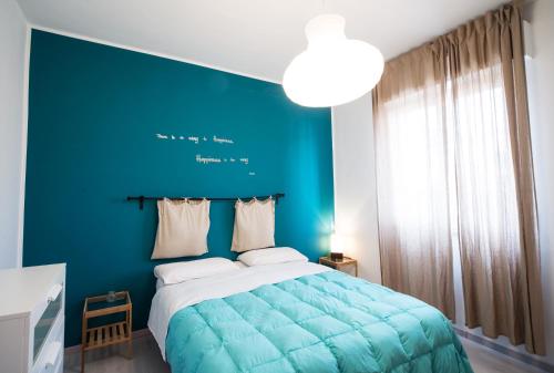 a blue bedroom with a bed with a blue wall at La Terrazza sul Mare in Letojanni