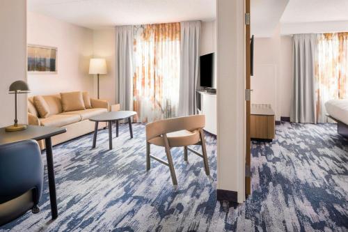 a living room with a couch and a table at Fairfield Inn & Suites – Buffalo Airport in Cheektowaga