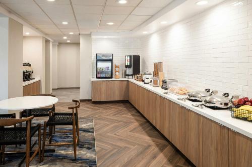 a lobby with a counter with chairs and a table at Fairfield Inn & Suites – Buffalo Airport in Cheektowaga