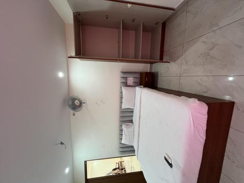 a bathroom with a towel rack and a mirror at Sln Homes in Bengaluru