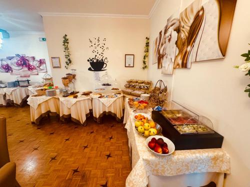 a room with two tables with food on it at Hotel Principe in Sanremo