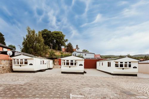 a group of white buildings in a parking lot at Villa Hexenholz in Thale