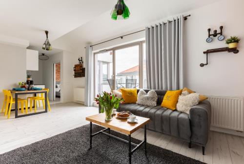 a living room with a couch and a table at Apartamenty Gdańsk EU - Waterlane in Gdańsk