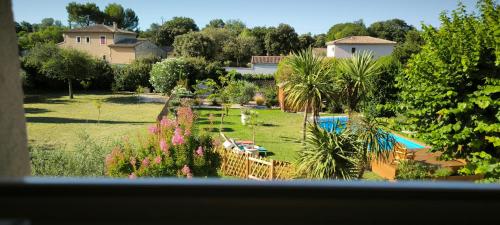 a view of a yard with a pool and trees at Au Nid de MesAnges in Colonzelle