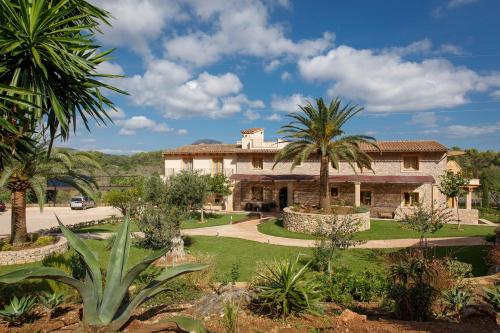 an estate with palm trees and a building at Agroturismo S'Arboçar in Sant Llorenç des Cardassar