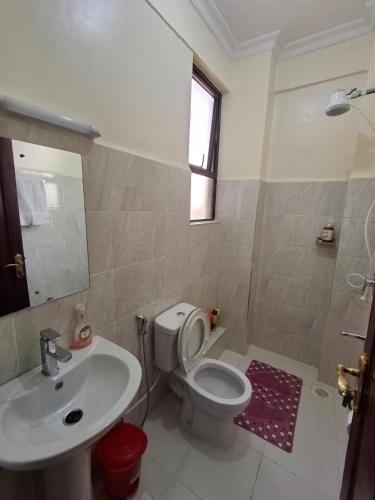 a bathroom with a white toilet and a sink at Lymak 2 Bedroom Hilltop Ngong in Ngong