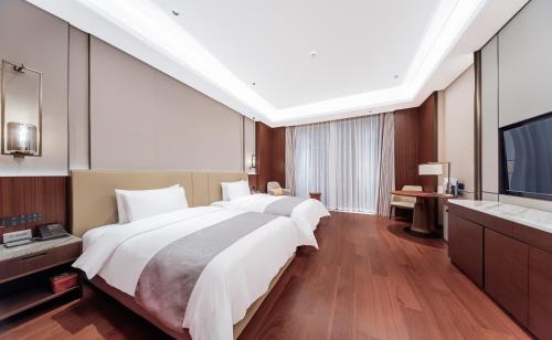 Ένα ή περισσότερα κρεβάτια σε δωμάτιο στο YISHUI GRAND HOTEl