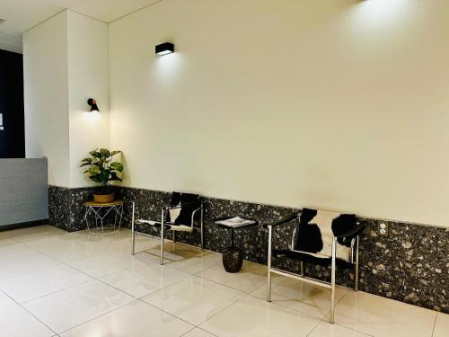 a waiting room with chairs and a wall at High-rise Beach Home in Busan in Busan