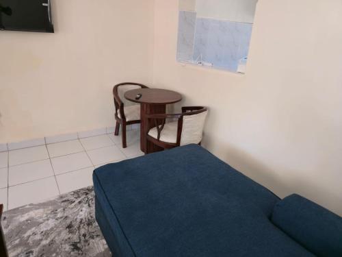 a living room with a couch and a table at Nyodera Homes Furnished Apartments in Oyugis